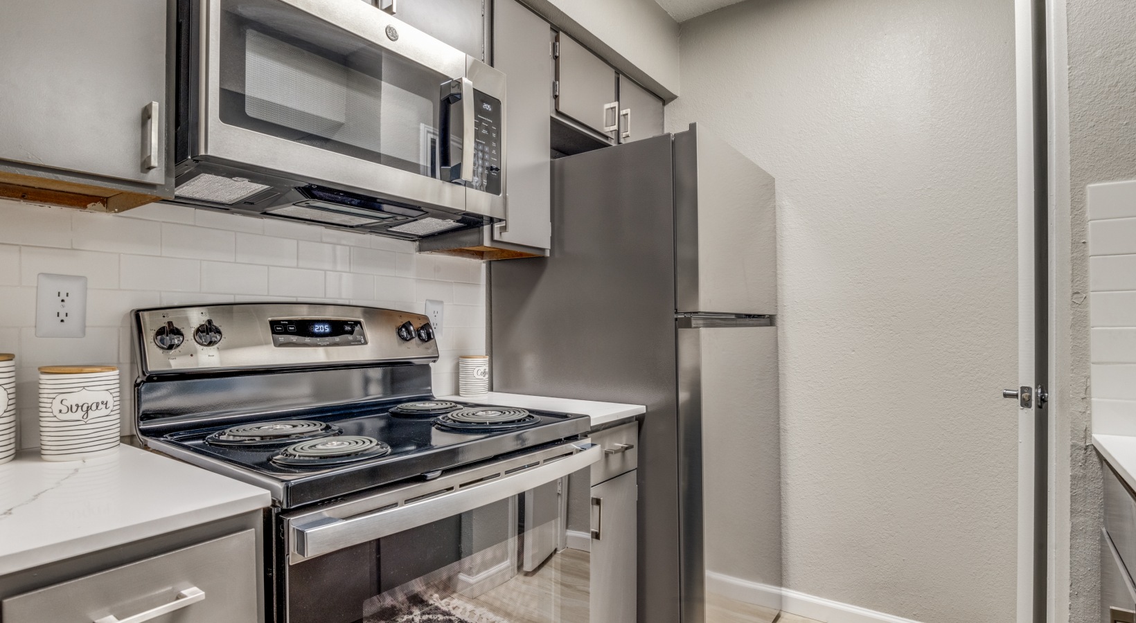 a kitchen with stainless steel appliances and a microwave at The  Durham